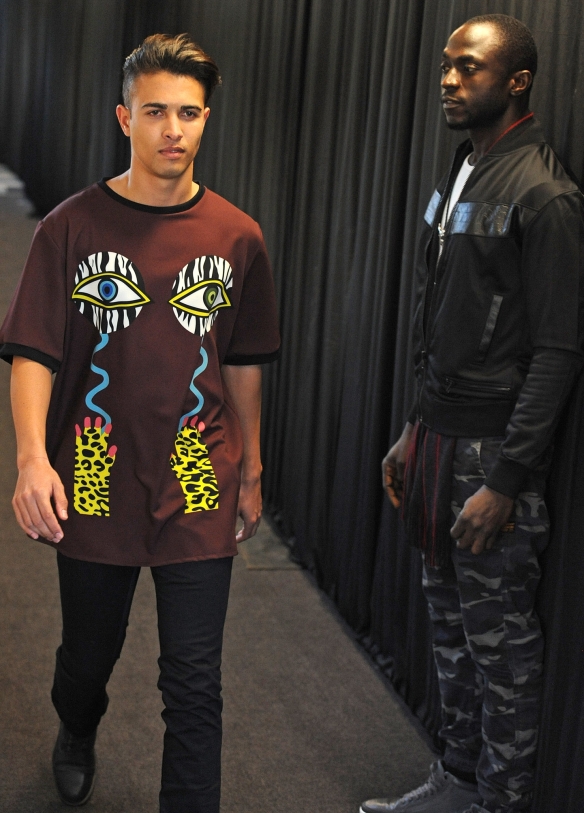 Jimi Owobo Ogunlaja of the Jimisterio Catwalk Academy teaching Keegan how to walk on the runway. Picture by Tracey Adams.  